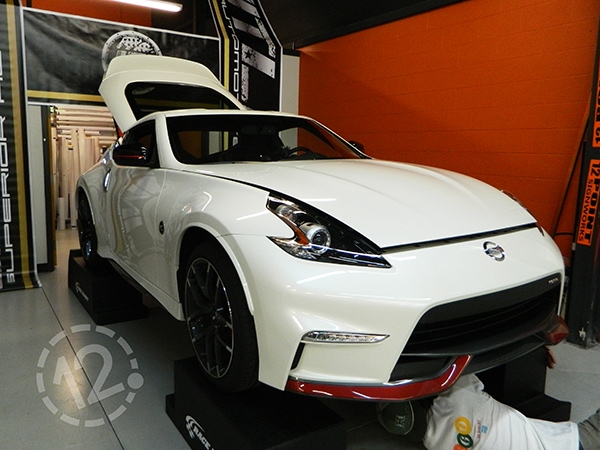 This photo shows the original, factory white paint on a 2016 Nissan 370Z NISMO. 12-Point SignWorks - Franklin, TN