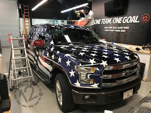Our installer is applying a full coverage color change wrap in our climate-controlled shop. 12-Point SignWorks - Franklin, TN