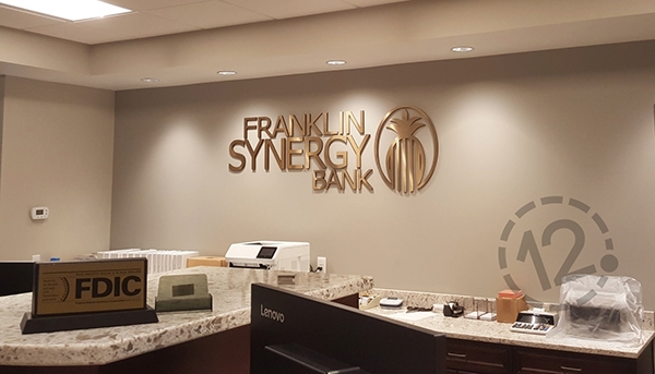 The dimensional logo sign adds a touch of class to the teller work area. 12-Point SignWorks - Franklin, TN