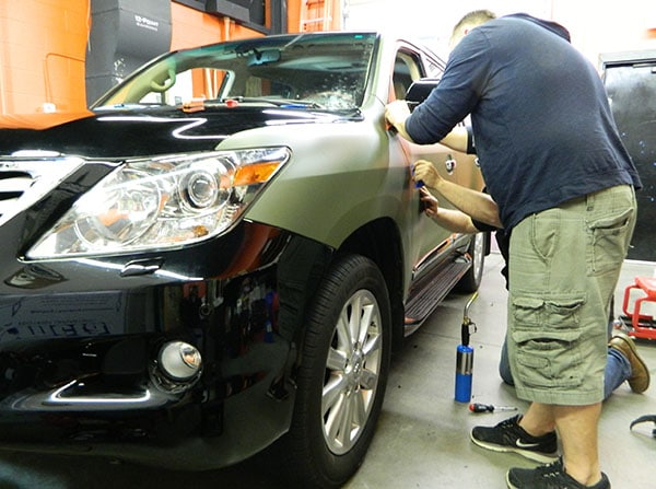 SUV matte wrap installation in progress. 12-Point SignWorks - Franklin TN