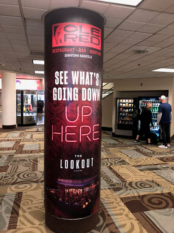 Airport column wrap for Associated Graphics installed by 12-Point SignWorks at the Nashville International Airport.