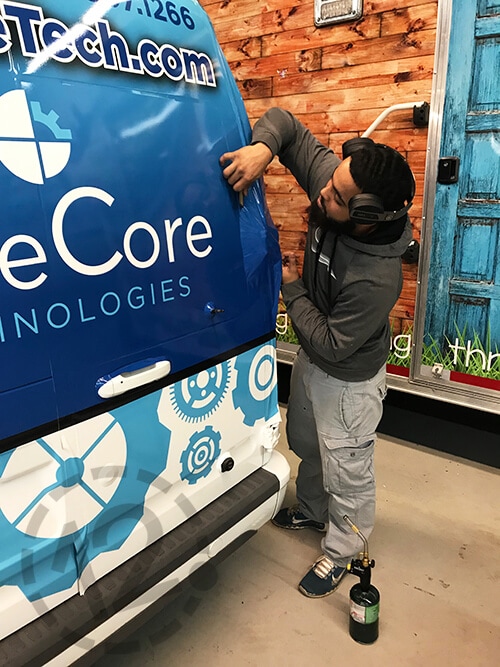 Attention to Detail During the Installation Process of BlueCore Technologies' Van Wrap. 12-Point SignWorks - Franklin, TN