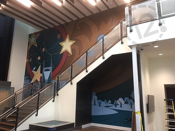 Wall mural installed above and below the stairs for Deloitte. 12-Point SignWorks - Franklin, TN