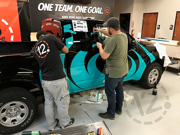 Installation of a custom vehicle wrap on a leased vehicle. 12-Point SignWorks - Franklin, TN