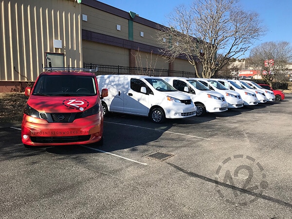Fleet of leased vans ready for vehicle wrap installation. 12-Point SignWorks - Franklin, TN
