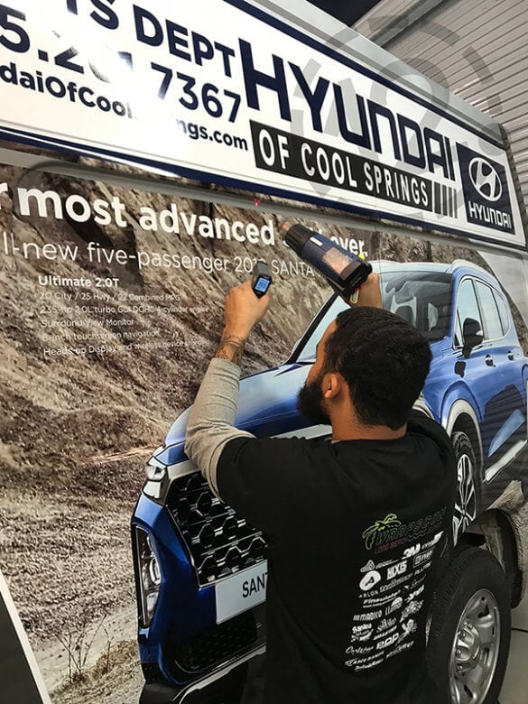 Heat setting a vinyl wrap for Hyundai of Cool Springs by 12-Point SignWorks in Franklin, TN. 