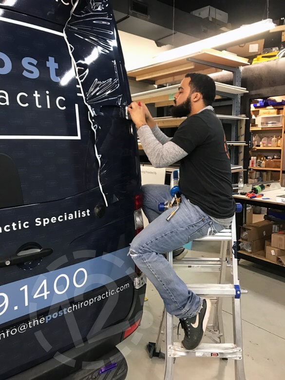 Installation of a vinyl wrap for The Post Chiropractic by 12-Point SignWorks in Franklin, TN.