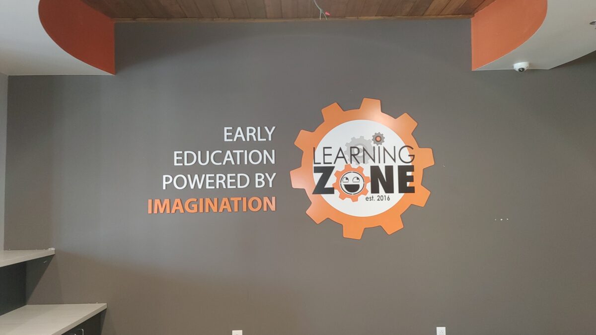 Learning Zone orange white and black sign