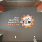 Learning Zone orange white and black sign