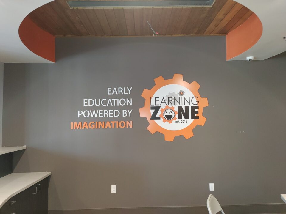 Learning Zone orange white and black sign